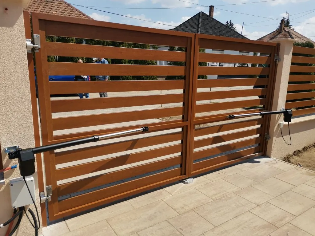 KingGates Linear csavarorsós kapunyitó motorpár antracit szürke színben, egy kovácsoltvas jellegű kétszárnyas kapura szerelve.